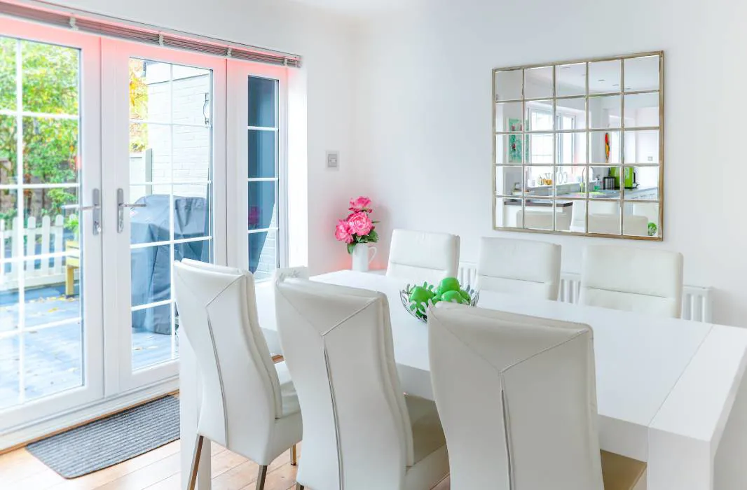 White dining room table and chairs with green fruit