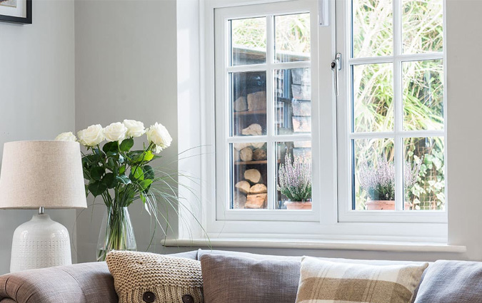 A white uPVC casement window with Georgian bars