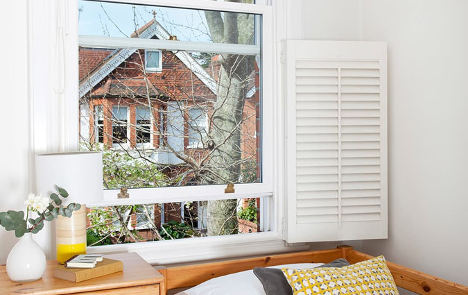 Slightly open sash window in a bedroom