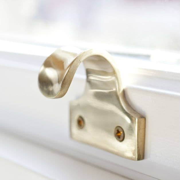 Close up of a hinge on a white Everest timber sash window