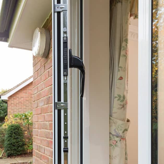 Close up of locking mechanism and black handle on a white Everest casement window