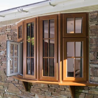 A brown woodgrain effect bow window