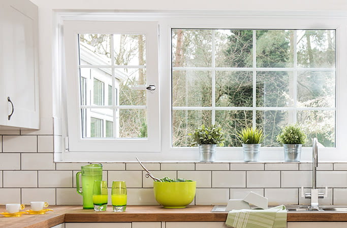 A large white tilt and turn window in a kitchen with one window tilted