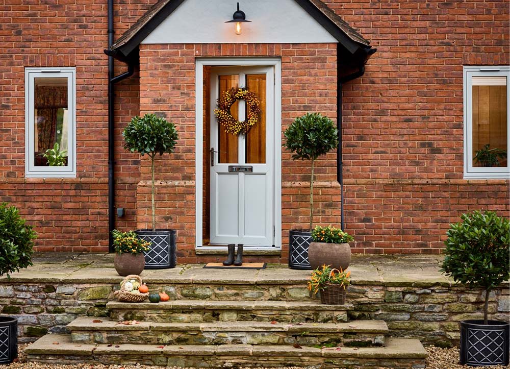 A white uPVC double glazed window with chrome handle and GrabLock from Yale