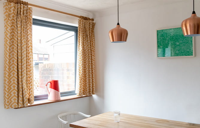 A modern dining room with lots of light through the slimline aluminium window