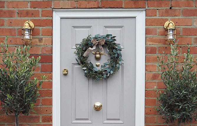 Front composite door in grey with gold furniture