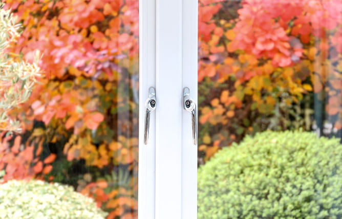 Chrome handles on a white uPVC window