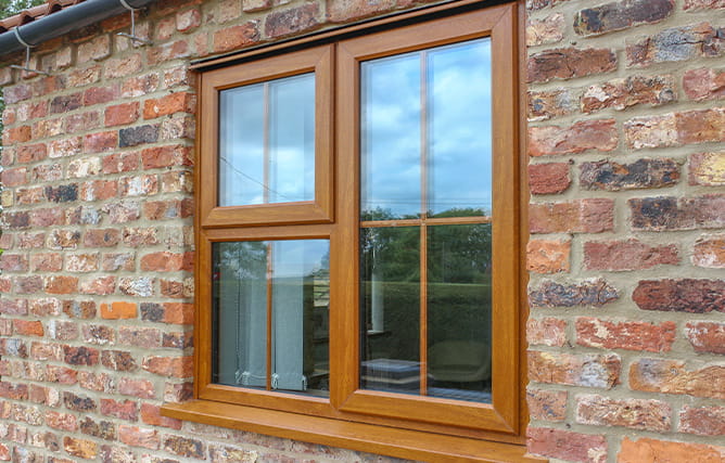 A uPVC golden oak window with Georgian bars