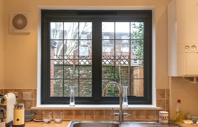 A black aluminium double glazed window with rectangular leading