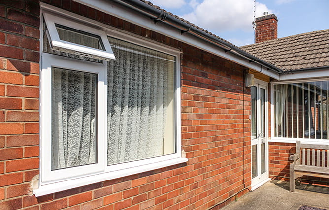 A white window at the front of a property