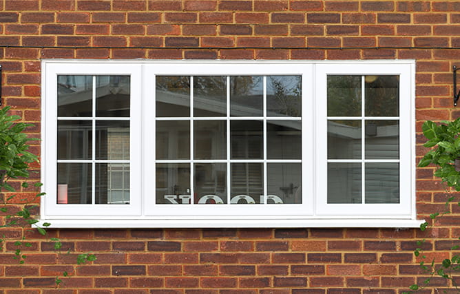 Outside view of a uPVC window with triple glazing and Georgian bars