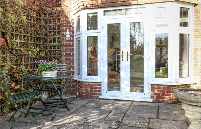 A set of white uPVC French doors with side windows