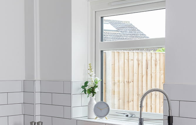 A uPVC window in a kitchen with chrome handle