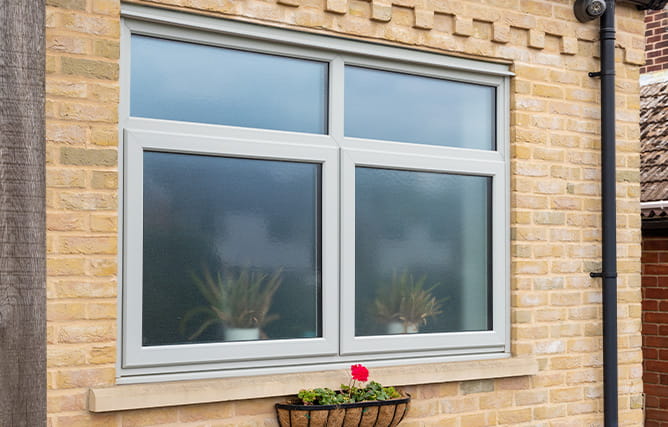 An open casement window white inside and anthracite grey on the outside