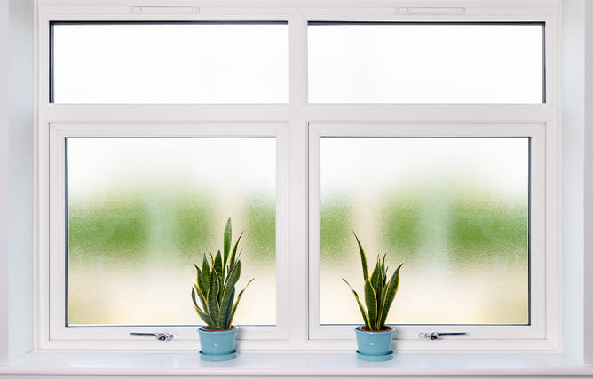 A uPVC casement window with obscure glass in a bathroom