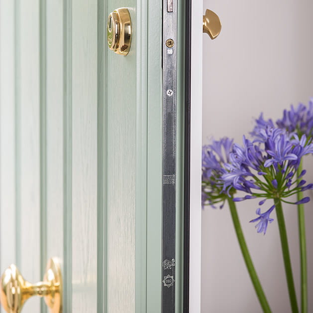 Close up view of a chartwell green composite front door