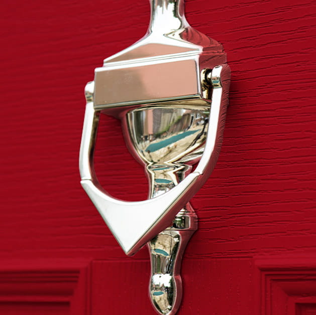 Door knocker on a red door