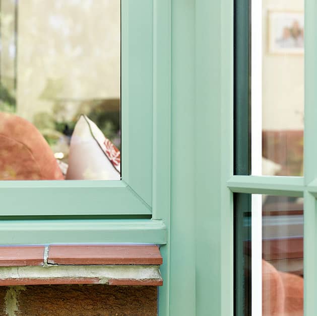 Close up of uPVC French windows in chartwell green