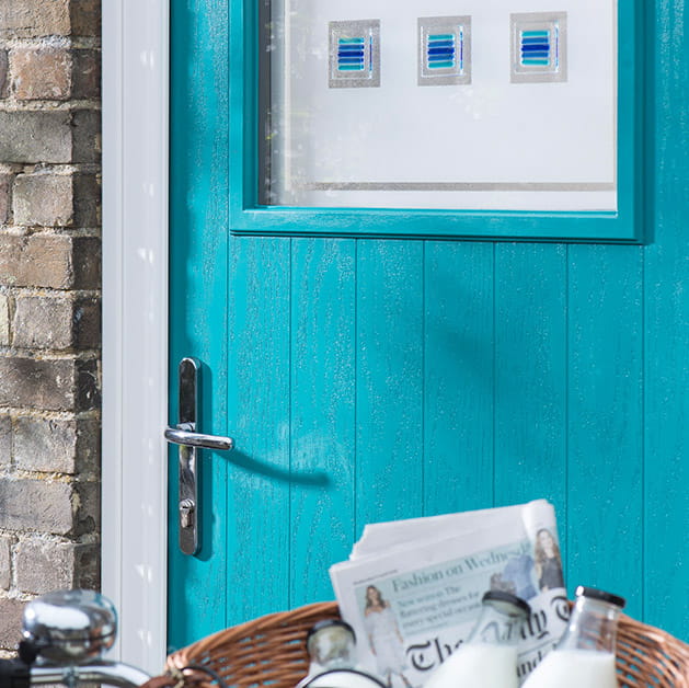 Peacock teal composite front door with decorative glass