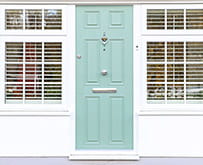 Chrome door knob on a green front door