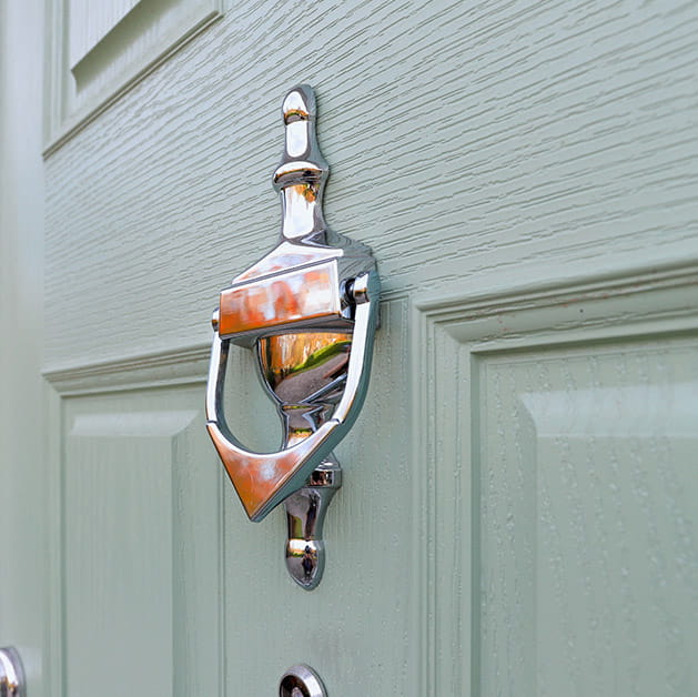 Chrome knocker on a chartwell green door