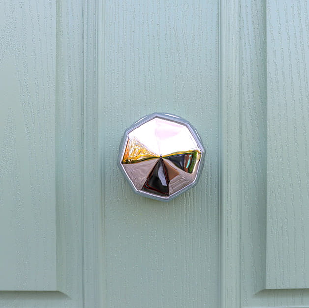 Chrome door knob on a green front door