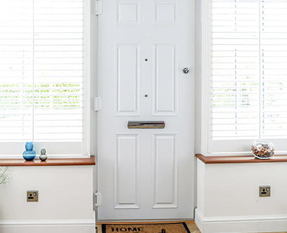 Secure white composite door with chrome furniture