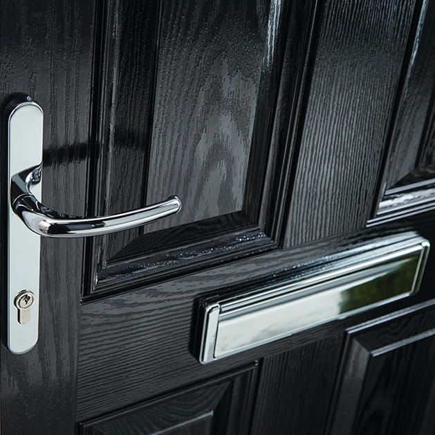 Black front door with chrome handle and letterbox