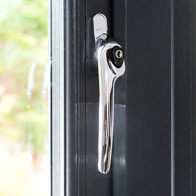 Chrome handle on a grey uPVC window