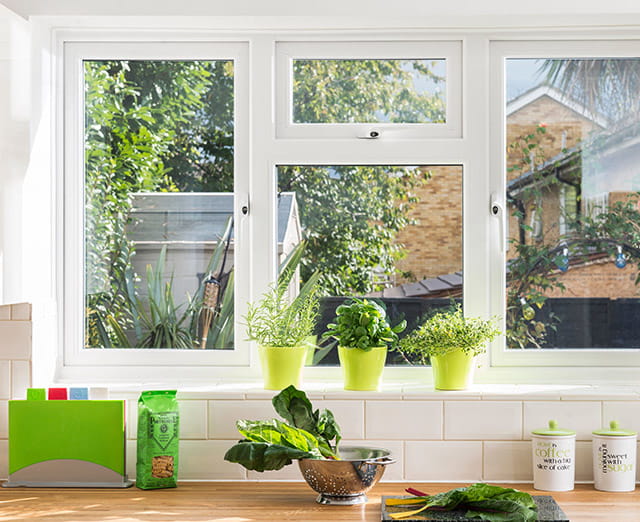 A kitchen with a white uPVC casement window