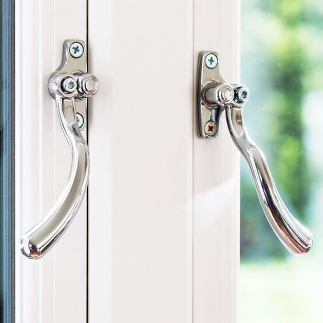 Stylish chrome handles on a white uPVC flush window