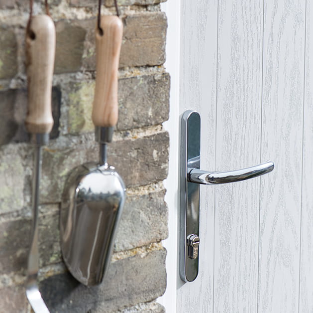 Chrome door handle on a grey front door