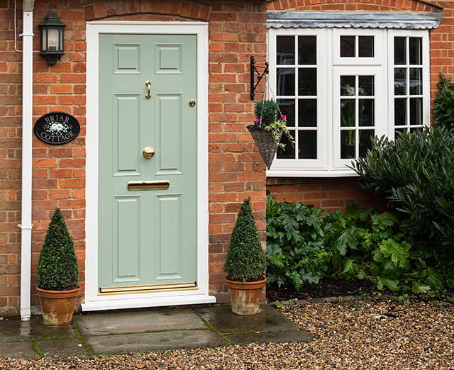 Close up view of a chartwell green composite front door