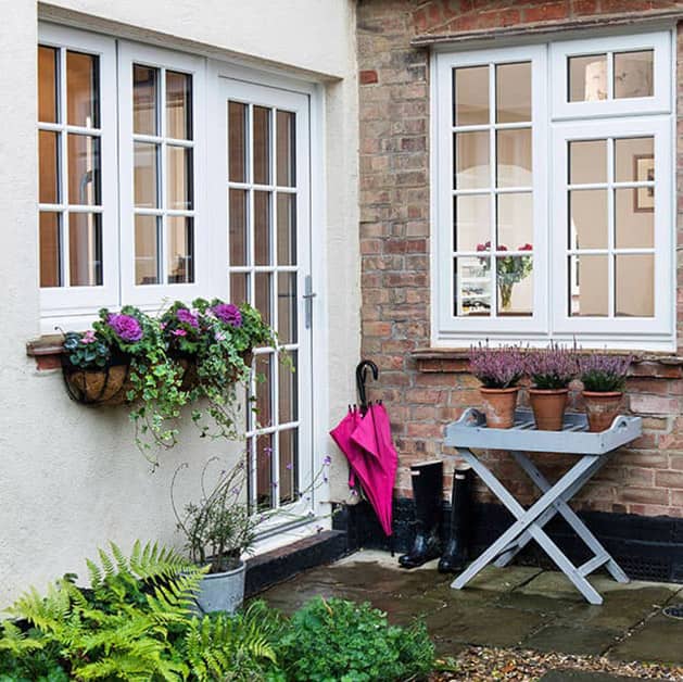 Outside view of white uPVC windows and door with Georgian bars