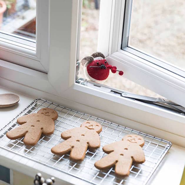 Kitchen white upvc window open slightly with christmas gingerbread men cooling