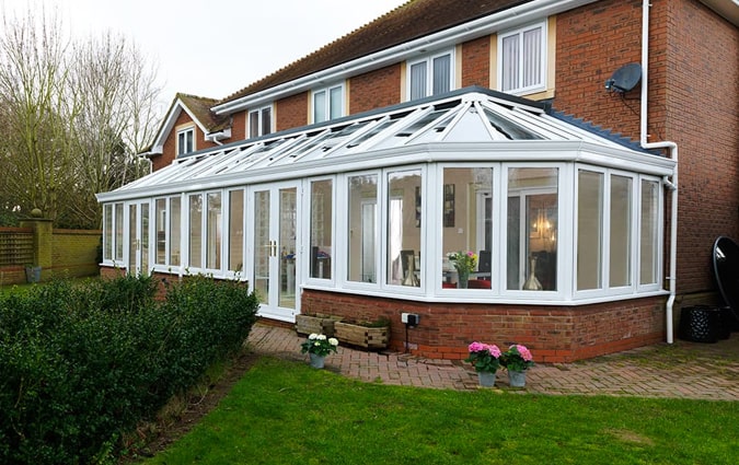 A grand uPVC classic conservatory with 2 sets of doors