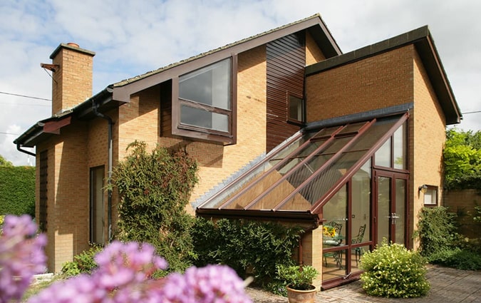 A brown uPVC lean-to conservatory