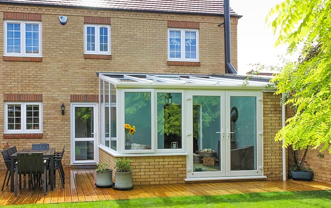 A small white uPVC lean-to conservatory