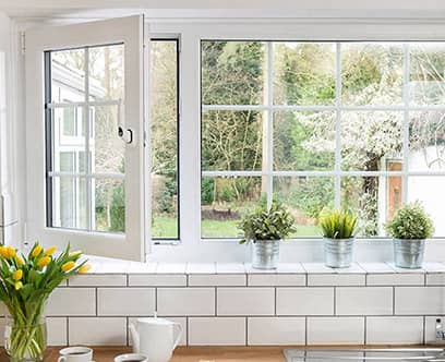 White uPVC sash window with Georgian bars and brass furniture