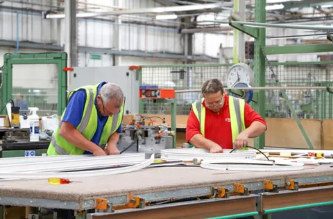 Workers assembling Everest conservatory parts in a factory