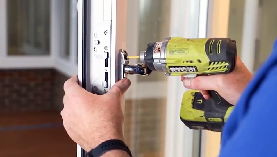 Person installing Everest conservatory window with cordless drill