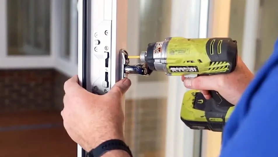 Person installing Everest conservatory window with cordless drill