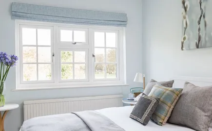 Light blue gingham window covering over white Everest conservatory windows