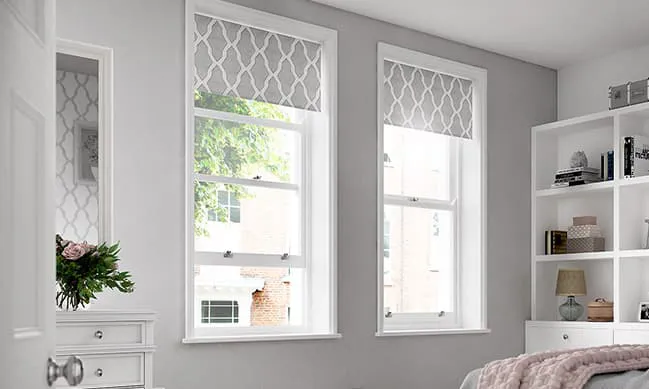 White windows with gray patterned blinds