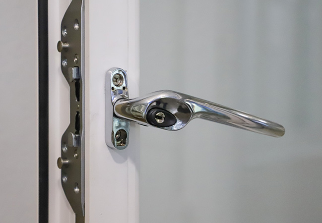 Chrome window handle on white Everest conservatory