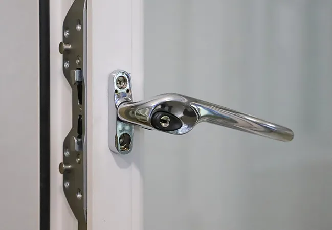 Chrome window handle on white Everest conservatory