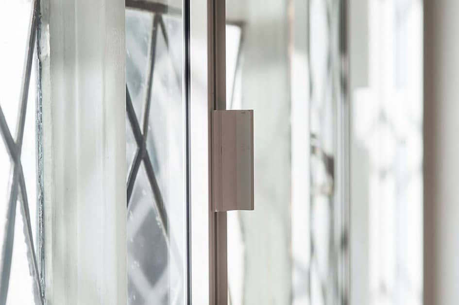 Close up of a white Everest secondary glazing window