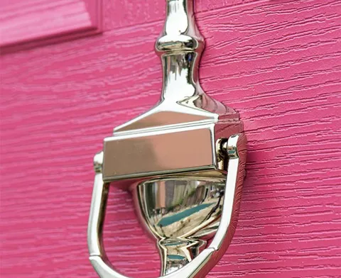 Pink door with a polished chrome door knocker