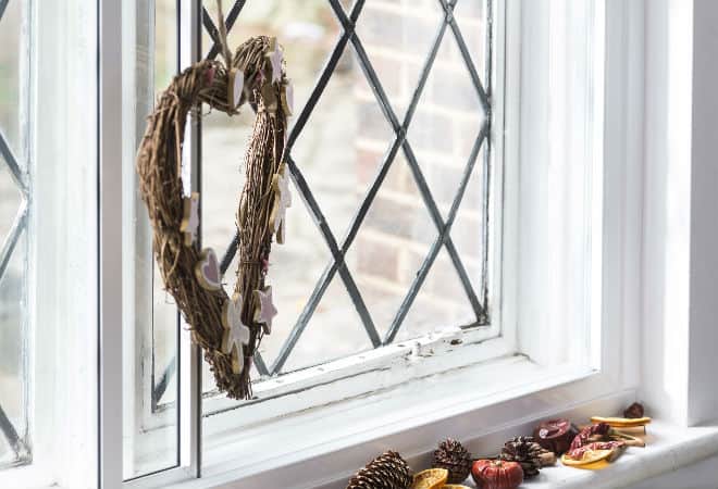 Heart shaped wreath with pastel decorations hanging on window