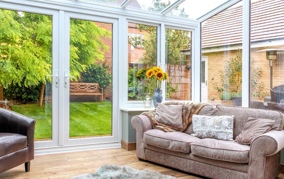 Everest conservatory with light-grey sofa and white frames